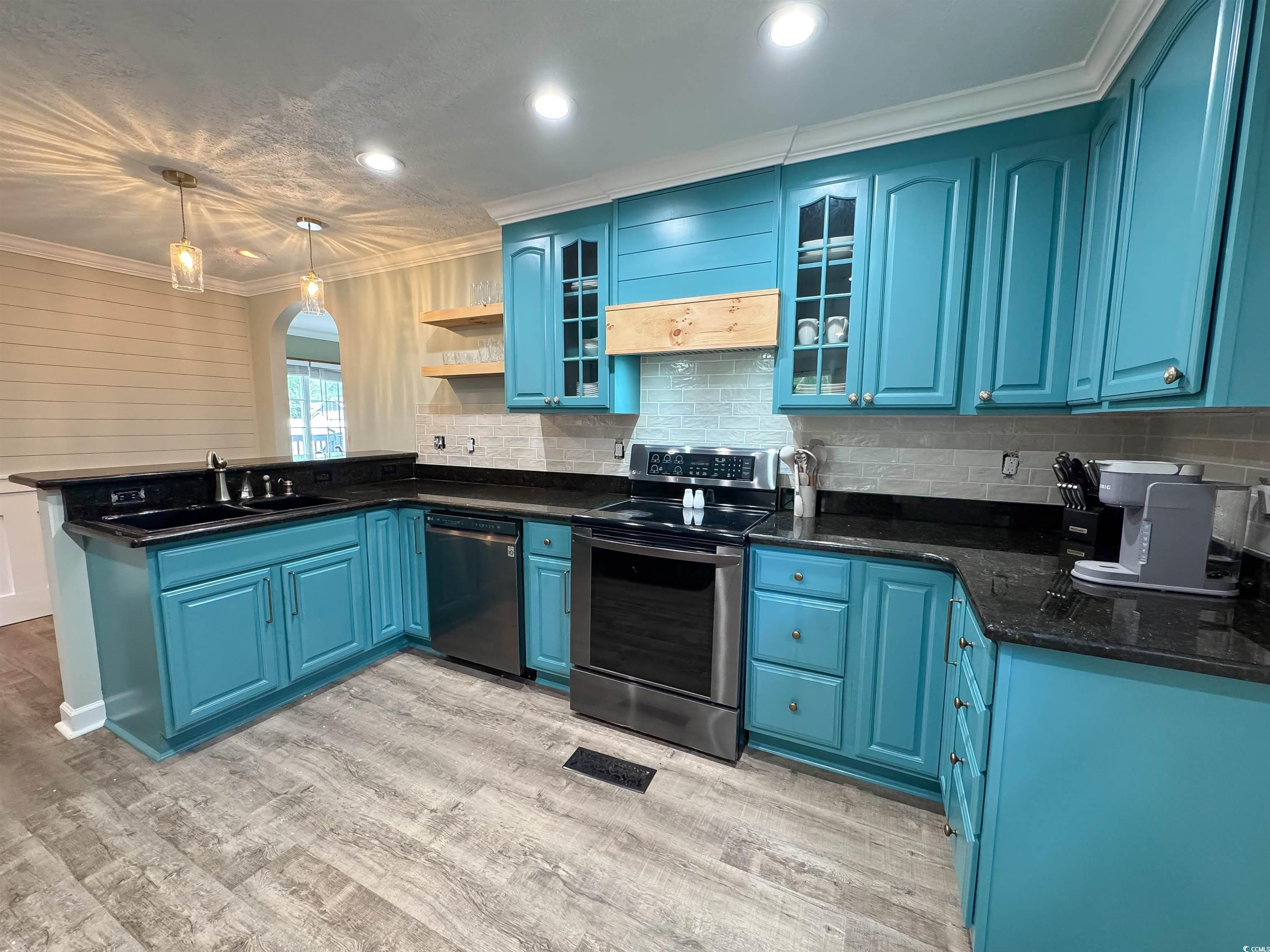 1014 Bay Drive Surfside Beach, SC 29575 - Photo 9 of 27 Kitchen featuring dishwashing machine, electric stove, blue cabinetry, a sink, and a peninsula