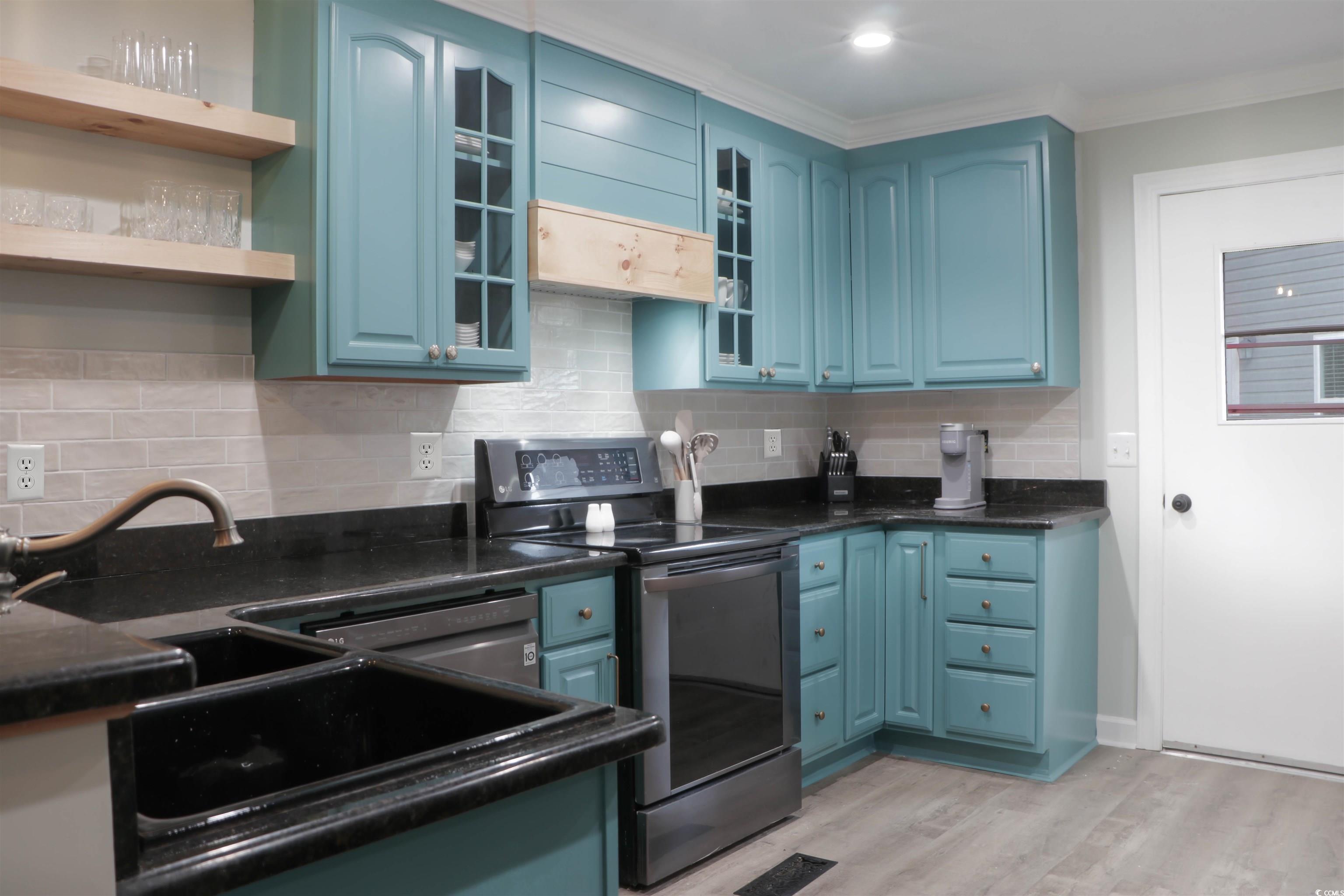 1014 Bay Drive Surfside Beach, SC 29575 - Photo 10 of 27 Kitchen with stainless steel range with electric cooktop, blue cabinetry, light wood finished floors, dark countertops, and crown molding