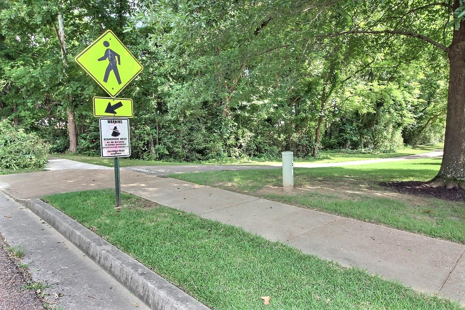 275 Home Place Collierville, TN 38017 - Photo 23 of 23 a street sign on a sidewalk next to a road
