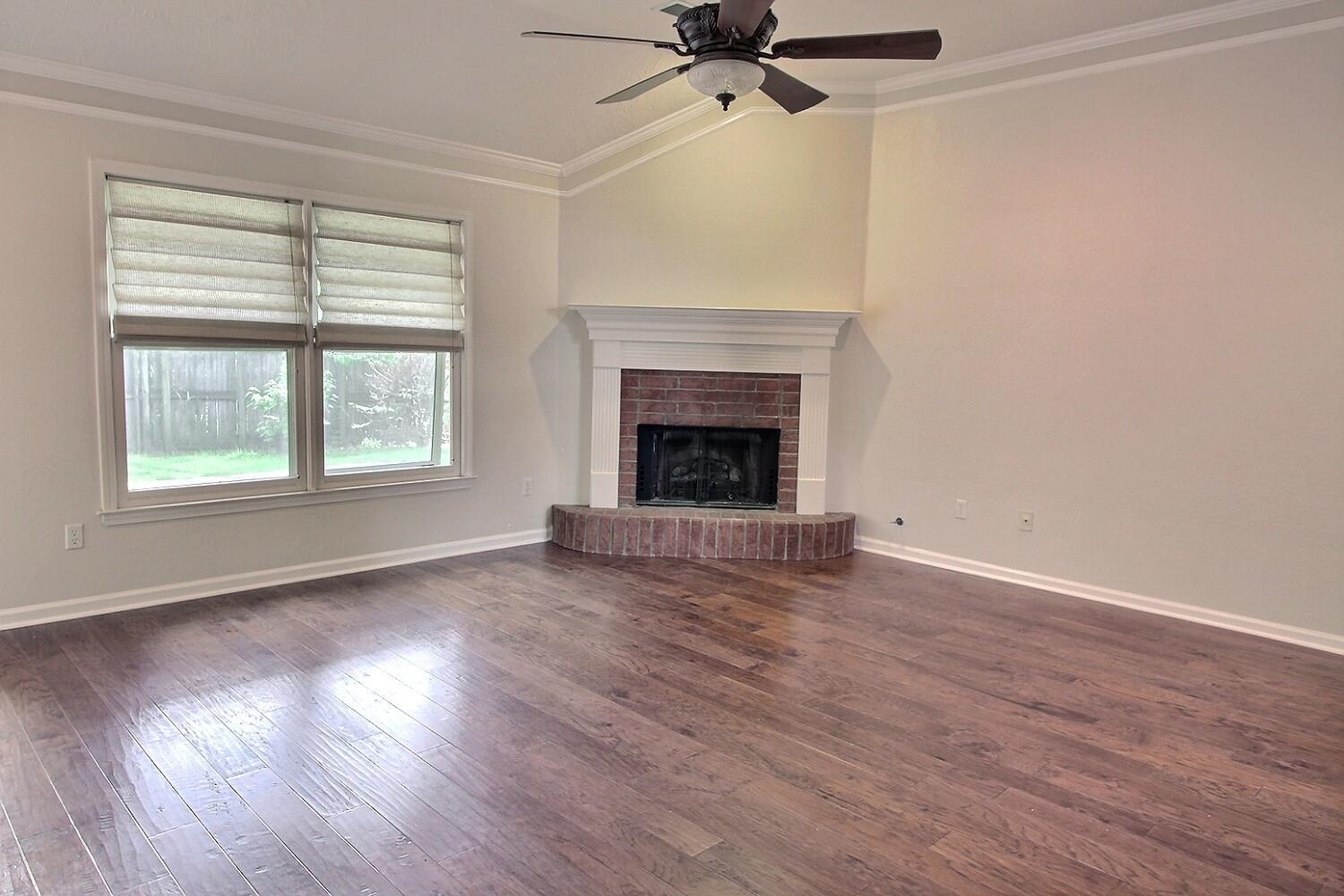 275 Home Place Collierville, TN 38017 - Photo 4 of 23 wooden floor fireplace and windows in an empty room
