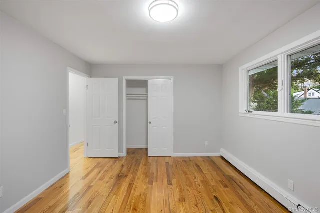 a view of a room with wooden floor and natural light