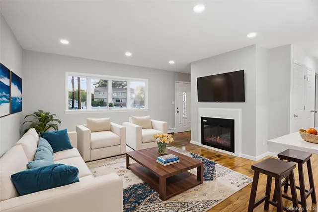 a living room with furniture a fireplace and a flat screen tv