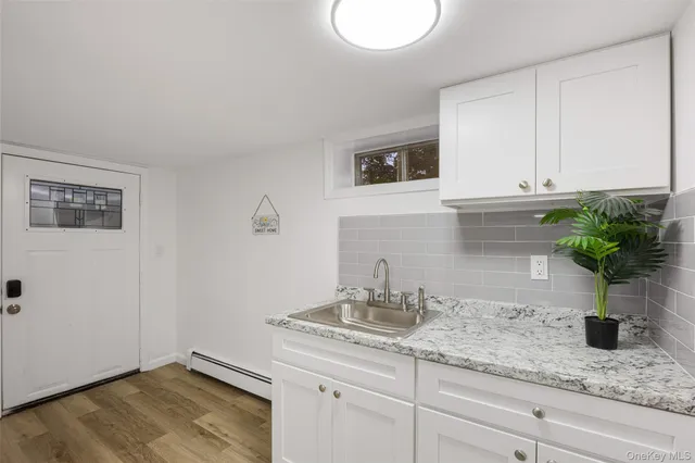 a view of a room with wooden floor and white walls