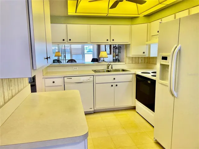 a kitchen with a sink a stove and cabinets