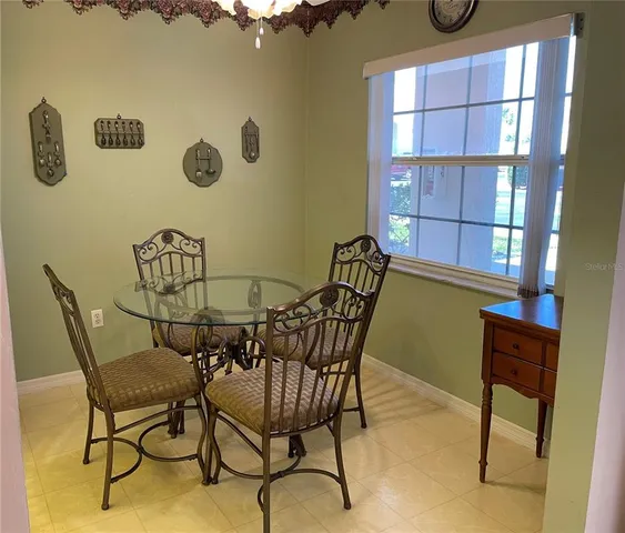 a view of a dining room with furniture and a window
