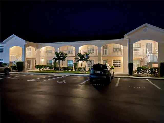 a living room with fireplace furniture and a large window