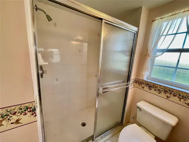 a bathroom with a shower and toilet