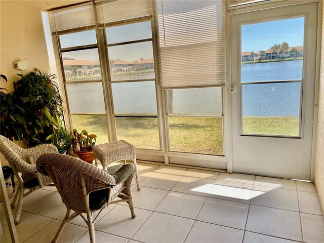 a living room with a large window and furniture