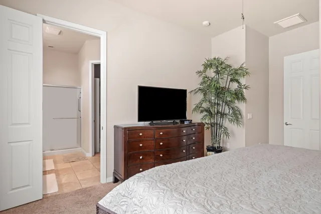 a bedroom with a bed and a flat screen tv