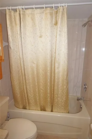 a bathroom with a toilet and a tub