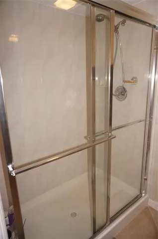 a bathroom with a glass shower door