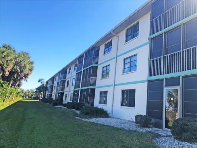 a view of a building with a yard