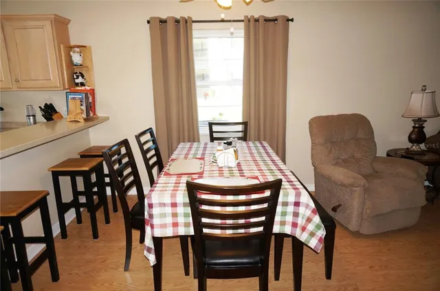 a view of a dining room with furniture and window