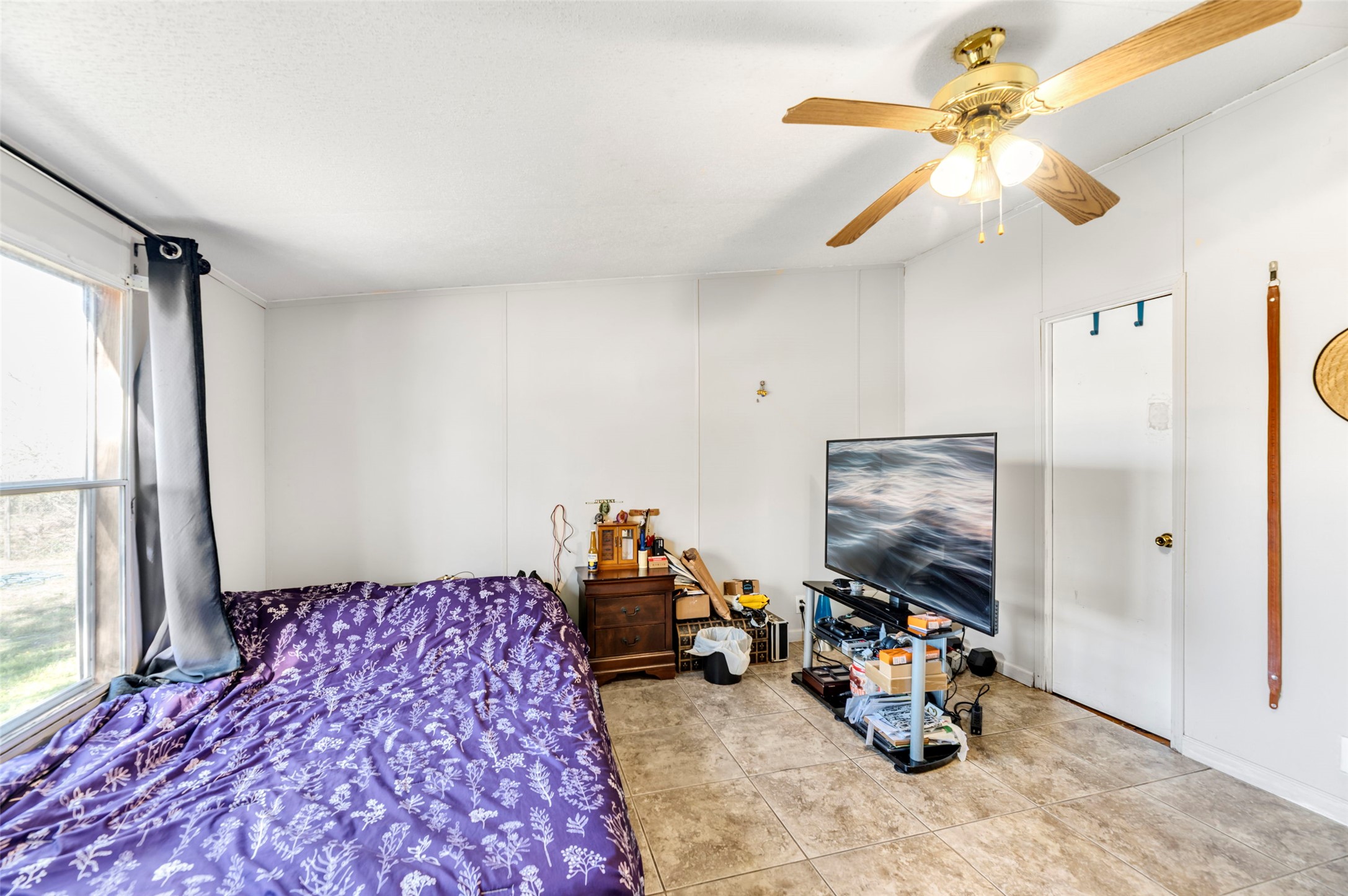 214 The Ranch Road Del Valle, TX 78617 - Photo 14 of 40 Bedroom with a ceiling fan and tile patterned floors