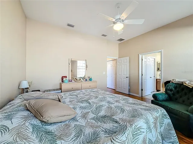 a bedroom with a bed dresser and a window