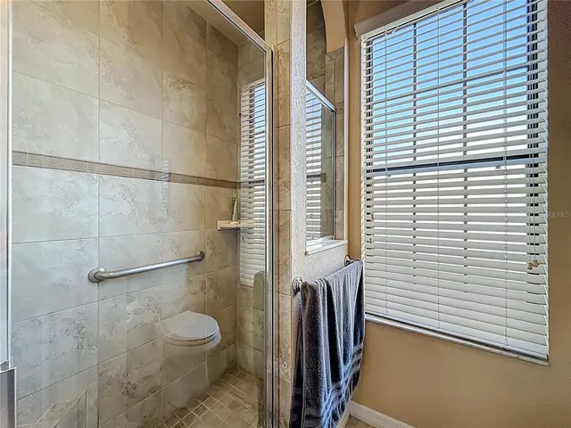 a bathroom with a toilet and a shower