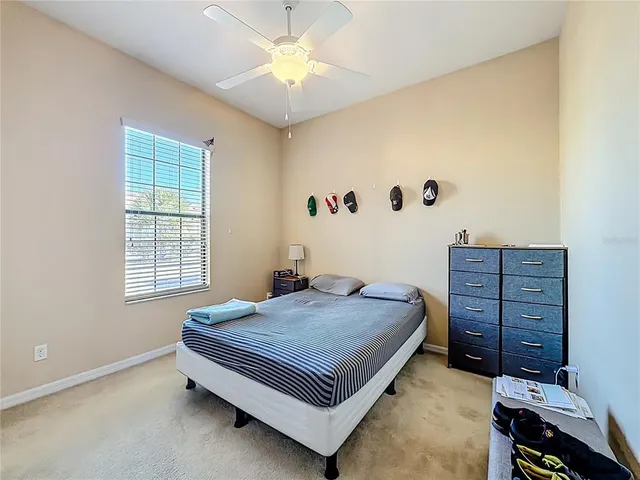 a bed sitting in a bedroom chandelier and dresser