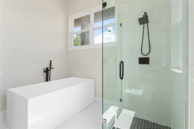 a bathroom with a granite countertop shower and a sink