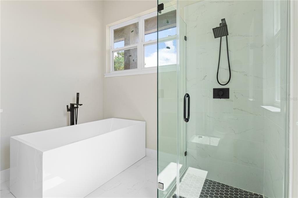 33328 County Road 473 Leesburg, FL 34788 - Photo 11 of 28 a bathroom with a granite countertop shower and a sink