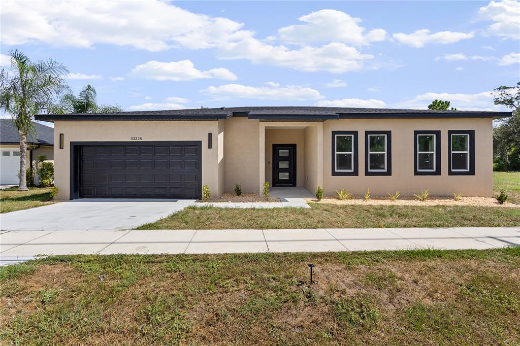 33328 County Road 473 Leesburg, FL 34788 - Photo 2 of 28 a front view of a house with a garden