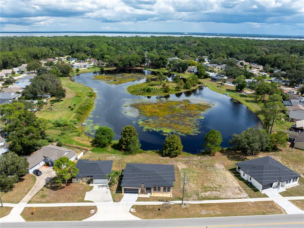 33328 County Road 473 Leesburg, FL 34788 - Photo 26 of 28 an aerial view of residential houses with outdoor space and lake view