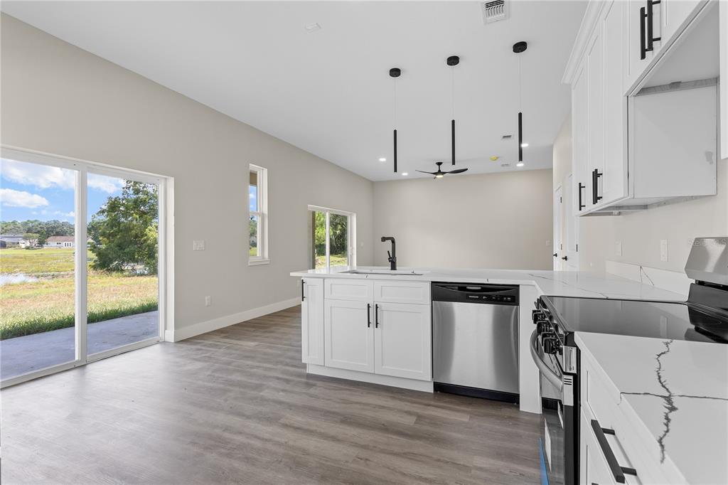 33328 County Road 473 Leesburg, FL 34788 - Photo 5 of 28 a kitchen with white cabinets and white appliances
