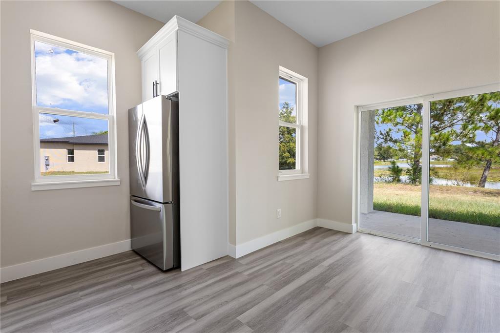 33328 County Road 473 Leesburg, FL 34788 - Photo 6 of 28 a view of empty room with wooden floor and fan