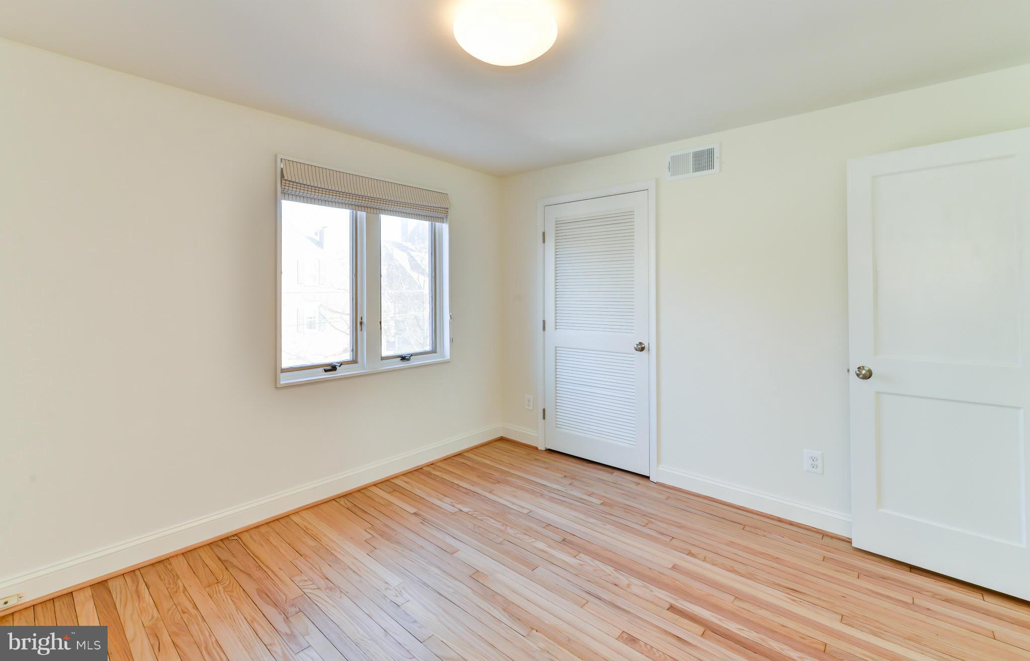 1138 Portner Road Alexandria, VA 22314 - Photo 14 of 30 an empty room with wooden floor and windows