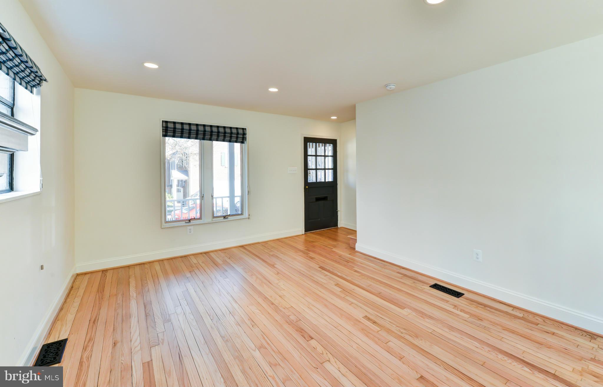 1138 Portner Road Alexandria, VA 22314 - Photo 8 of 30 a view of an empty room with wooden floor and a window
