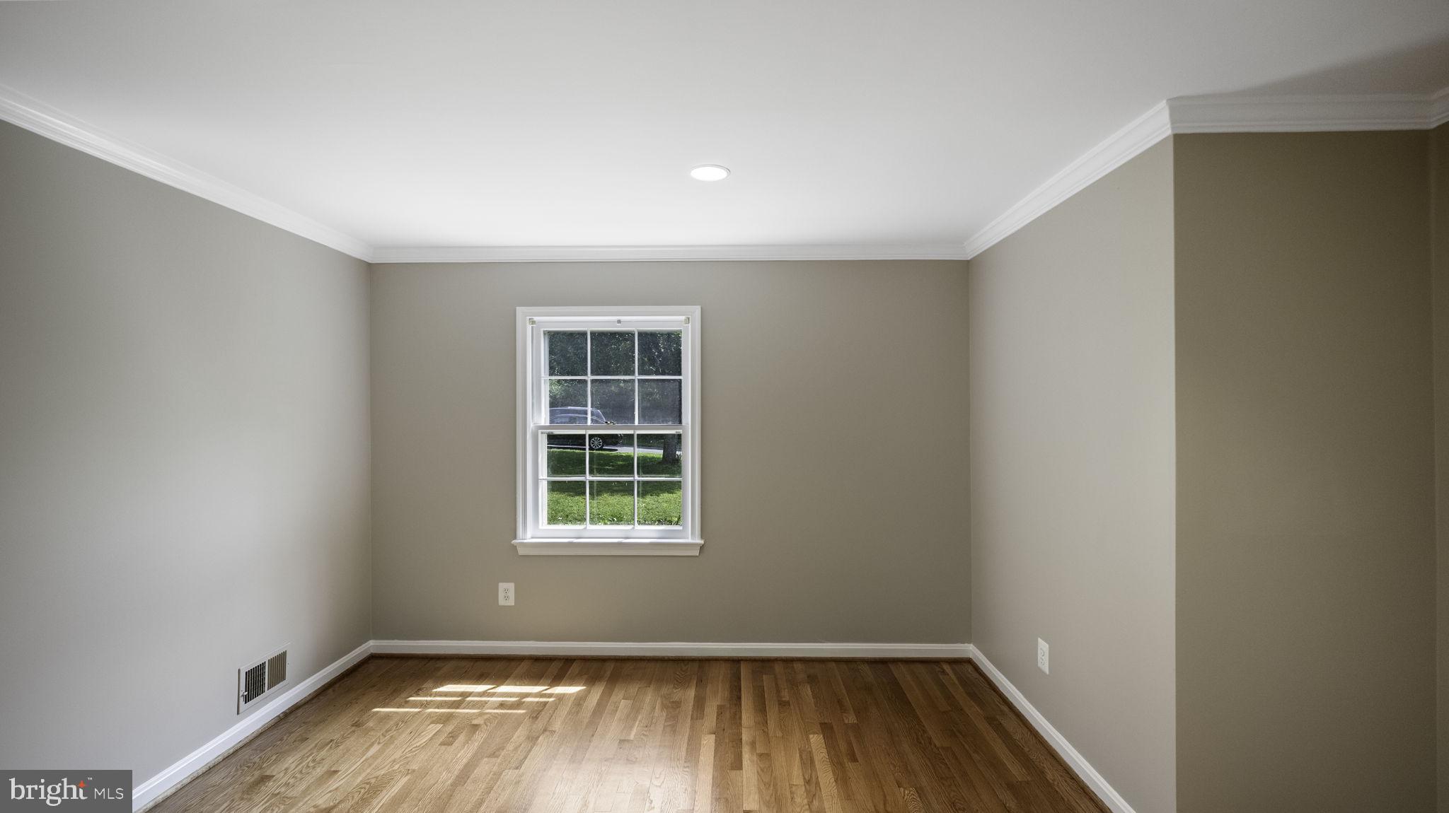 9705 Eclipse Place Montgomery Village, MD 20886 - Photo 11 of 54 an empty room with wooden floor and windows