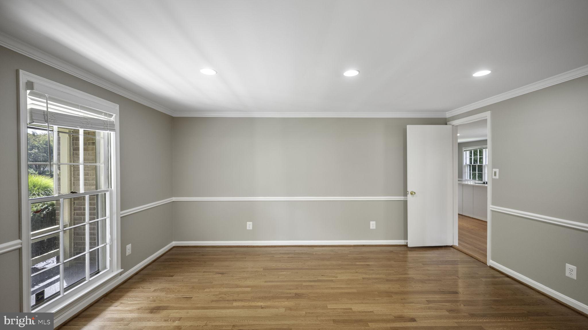 9705 Eclipse Place Montgomery Village, MD 20886 - Photo 12 of 54 a view of an empty room with wooden floor and a window