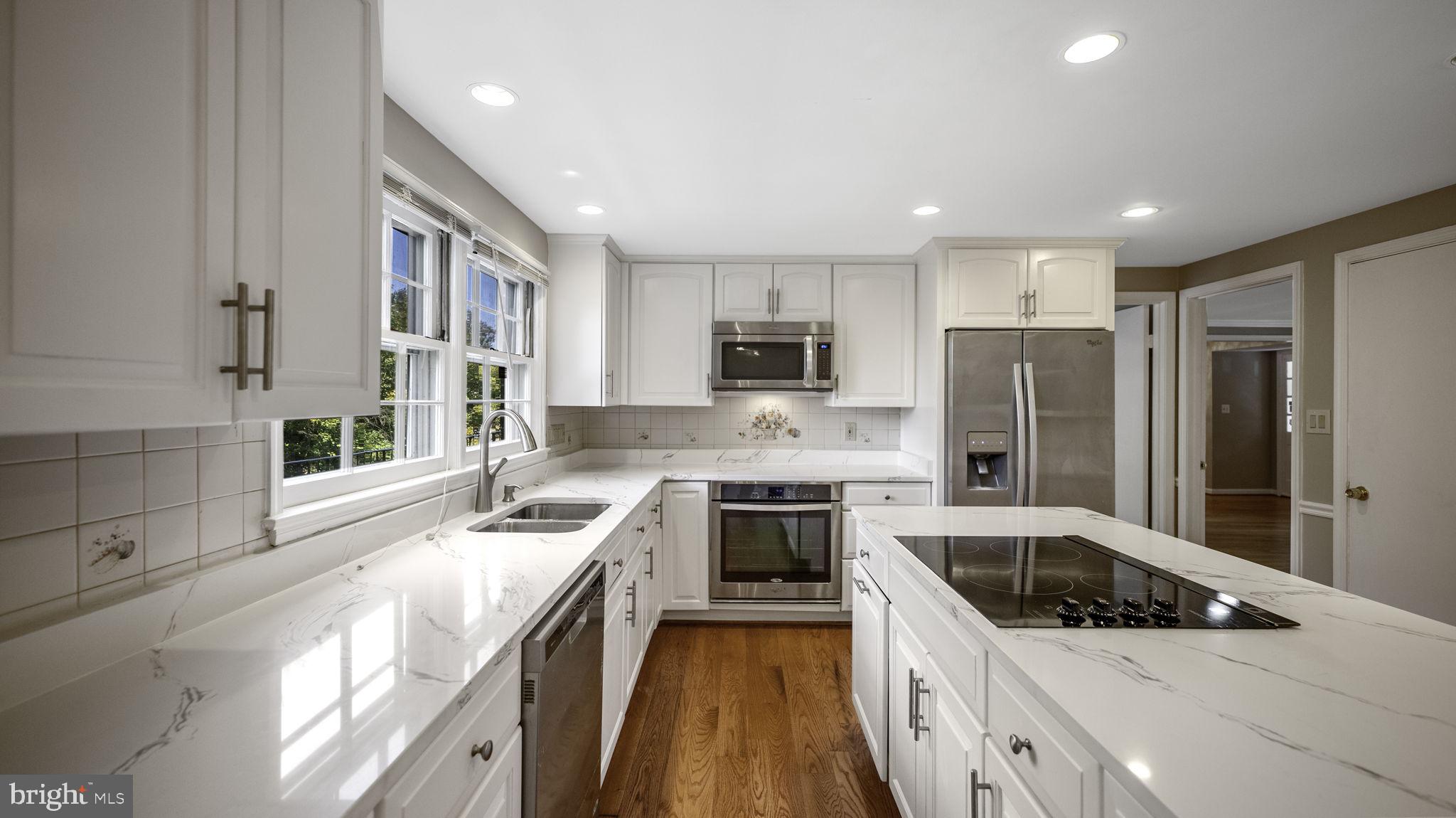 9705 Eclipse Place Montgomery Village, MD 20886 - Photo 19 of 54 a kitchen with a stove a sink and a refrigerator