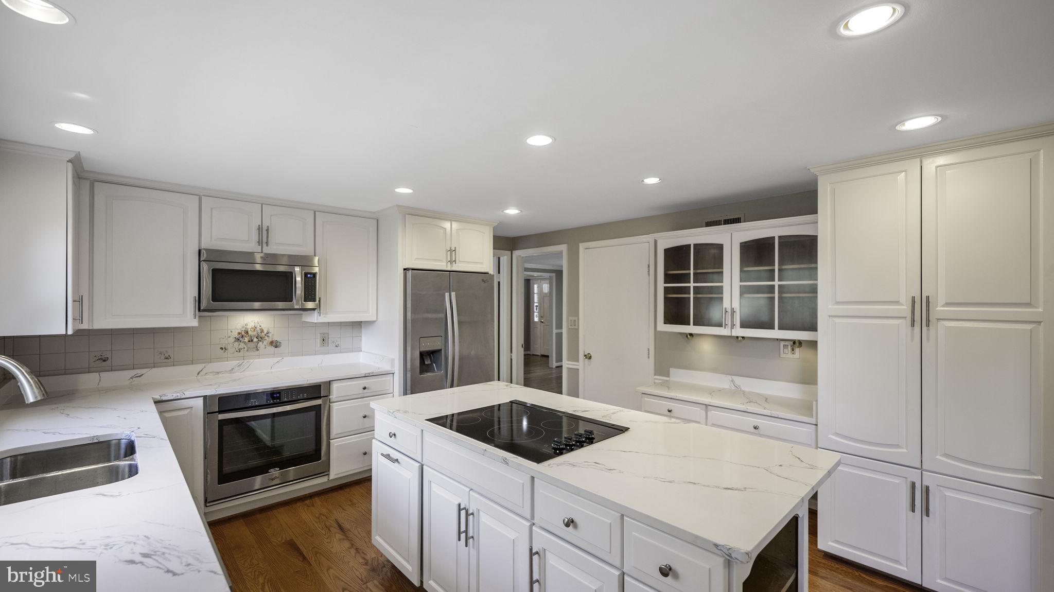 9705 Eclipse Place Montgomery Village, MD 20886 - Photo 20 of 54 a kitchen with a refrigerator and a stove top oven