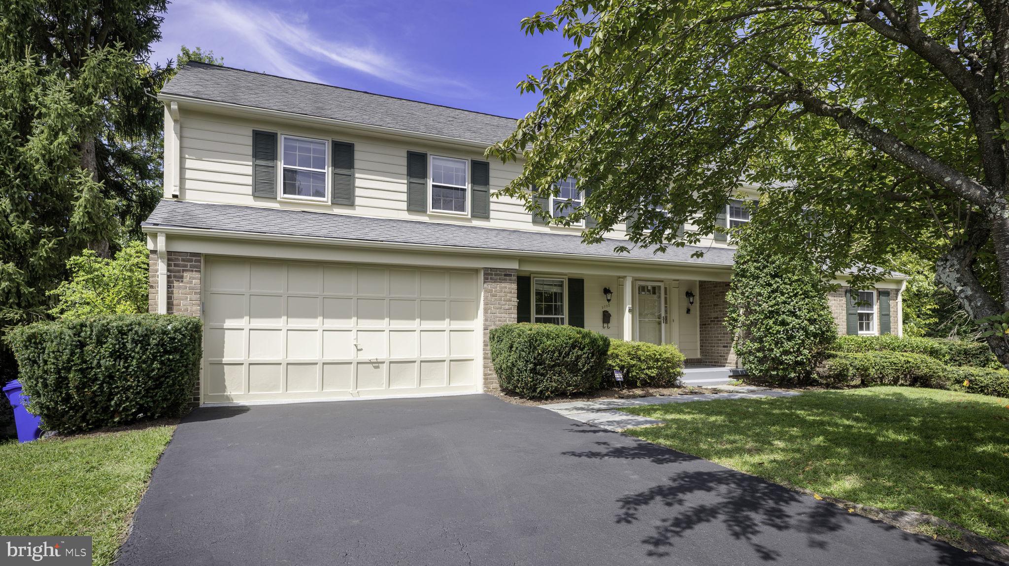 9705 Eclipse Place Montgomery Village, MD 20886 - Photo 2 of 54 a front view of a house with a yard and garage