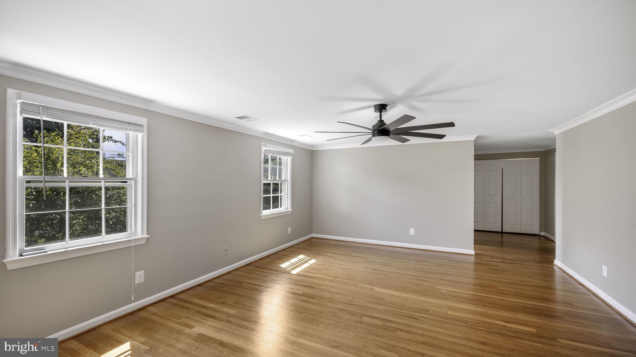 9705 Eclipse Place Montgomery Village, MD 20886 - Photo 26 of 54 a view of empty room with wooden floor and fan