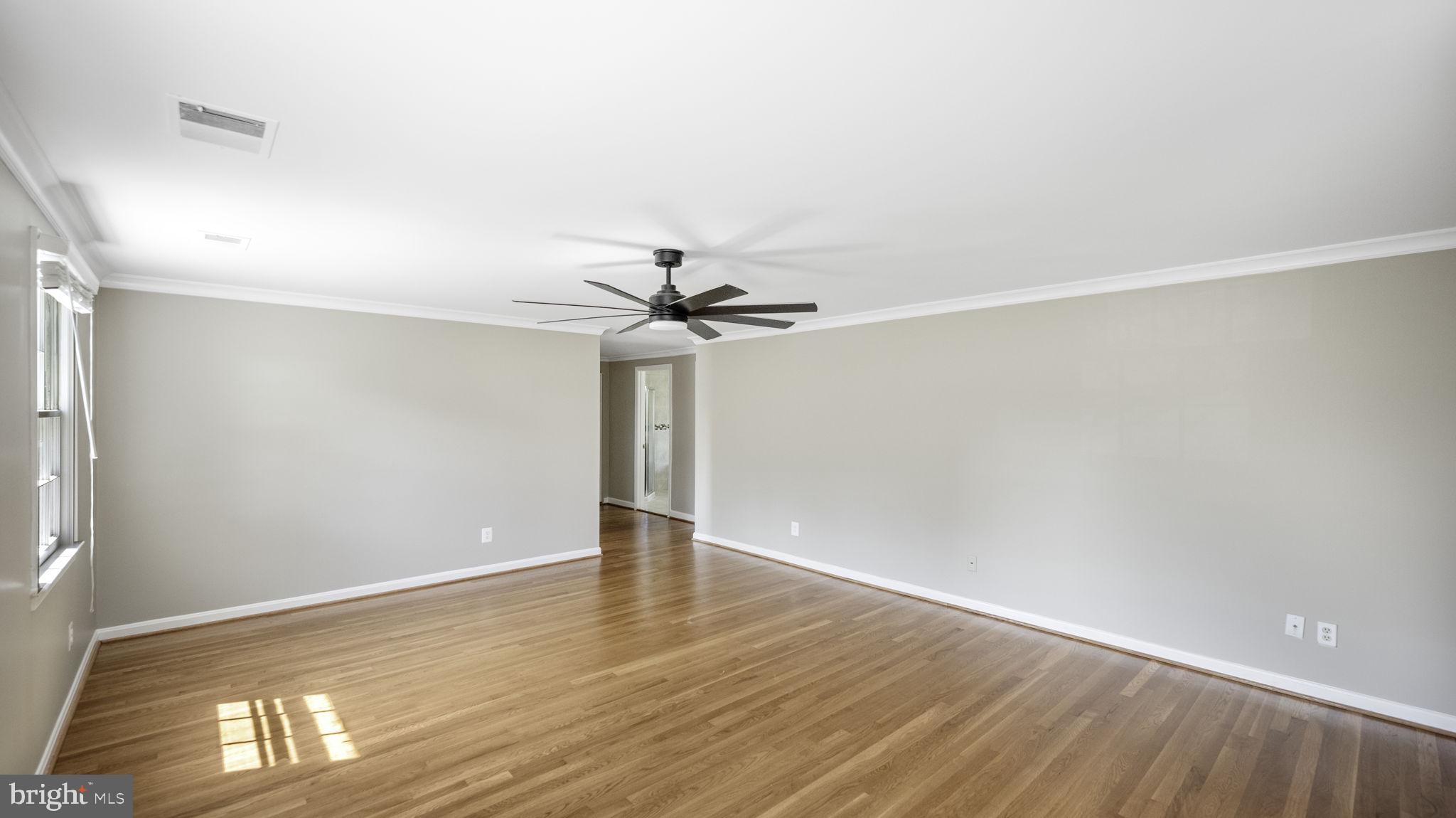 9705 Eclipse Place Montgomery Village, MD 20886 - Photo 27 of 54 a view of an empty room with wooden floor and a window