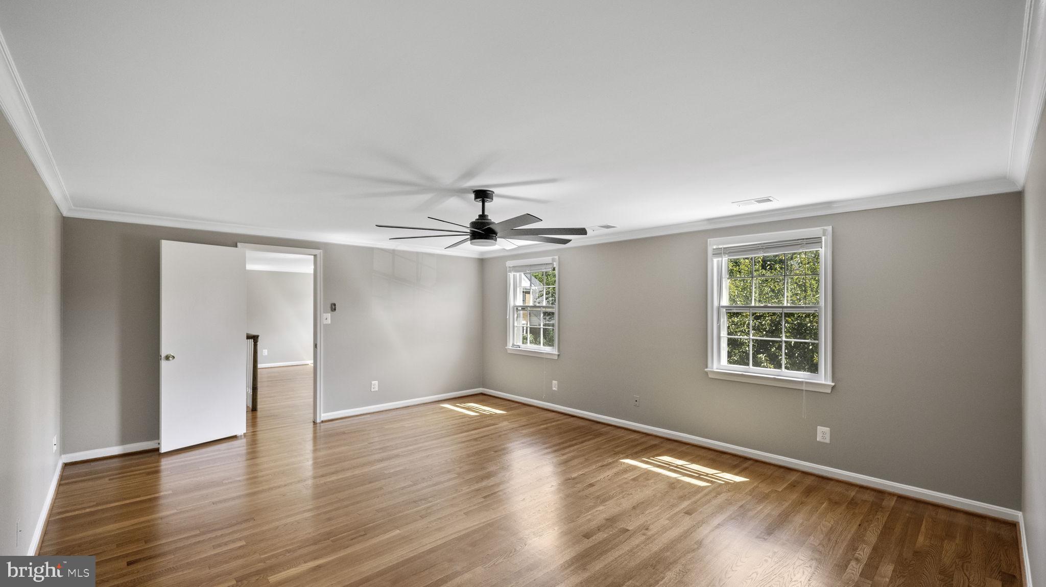 9705 Eclipse Place Montgomery Village, MD 20886 - Photo 28 of 54 a view of an empty room with wooden floor and a window
