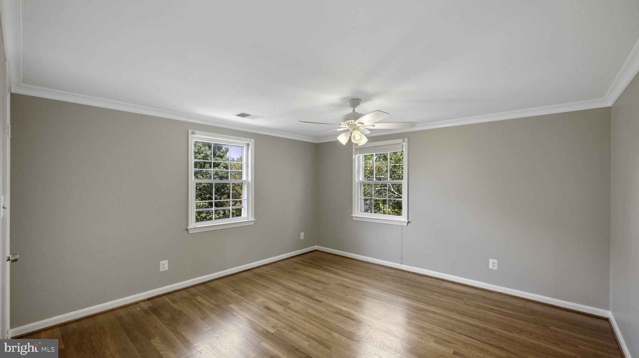 9705 Eclipse Place Montgomery Village, MD 20886 - Photo 36 of 54 a view of an empty room with a window and wooden floor