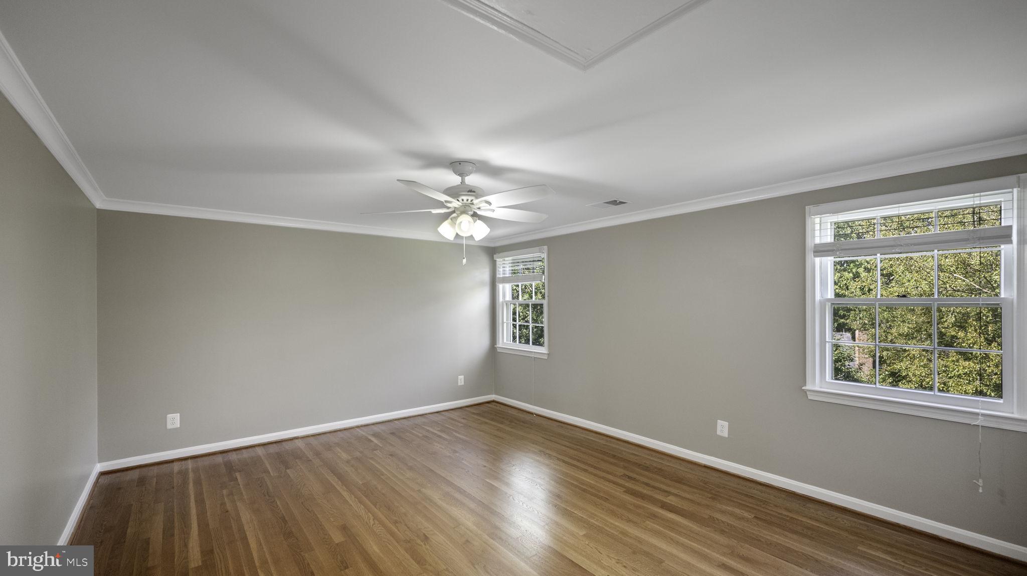 9705 Eclipse Place Montgomery Village, MD 20886 - Photo 39 of 54 a view of an empty room with wooden floor and a window