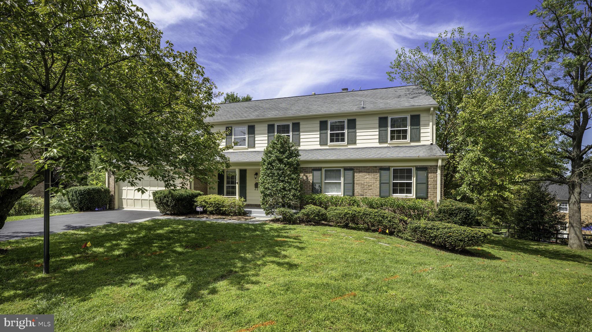 9705 Eclipse Place Montgomery Village, MD 20886 - Photo 4 of 54 a front view of a house with a yard and trees