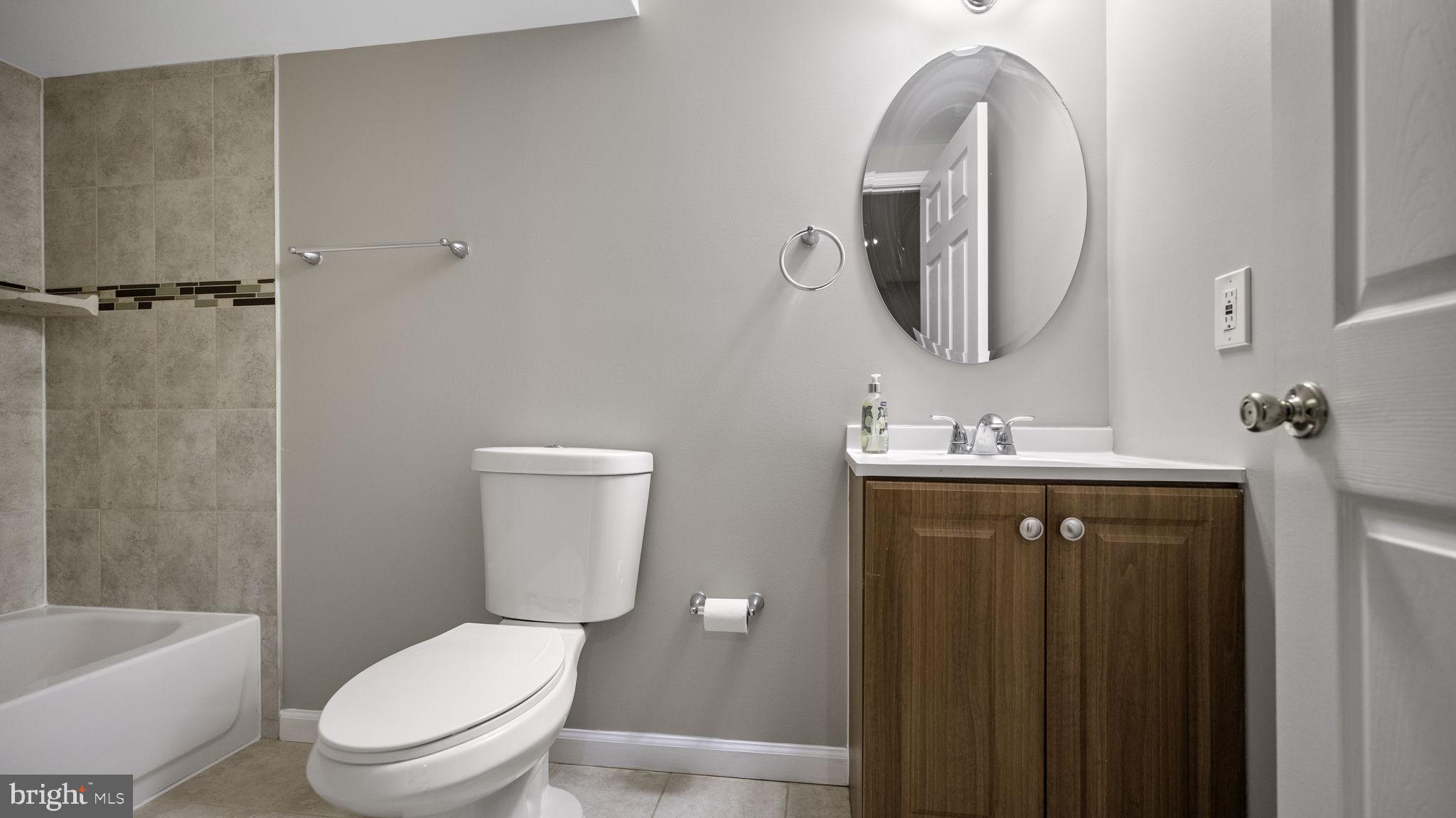 9705 Eclipse Place Montgomery Village, MD 20886 - Photo 52 of 54 a bathroom with a toilet a sink a tub and mirror