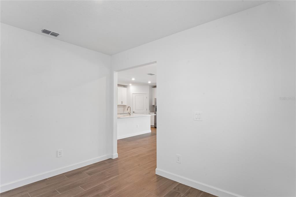 6692 Homebound Way New Port Richey, FL 34653 - Photo 28 of 47 a view of empty room with wooden floor