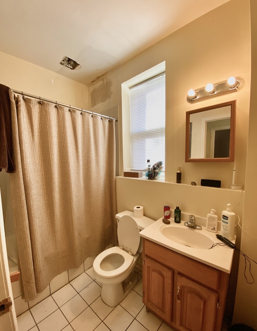 2610 West Thomas Street, Unit 1F Chicago, IL 60622 - Photo 7 of 13 a bathroom with a double vanity sink and mirror