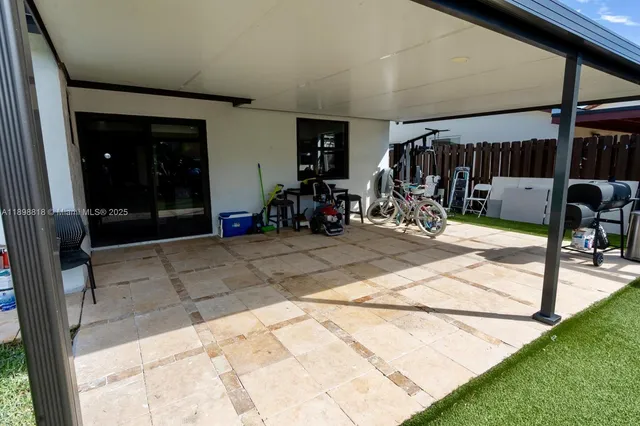a view of a porch with a table and chairs
