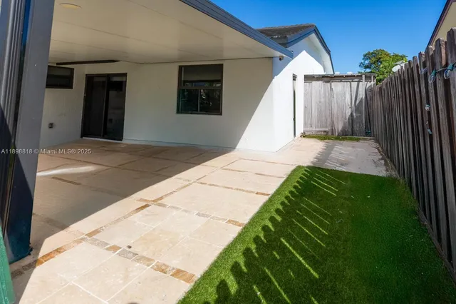 a view of backyard with tub and stairs
