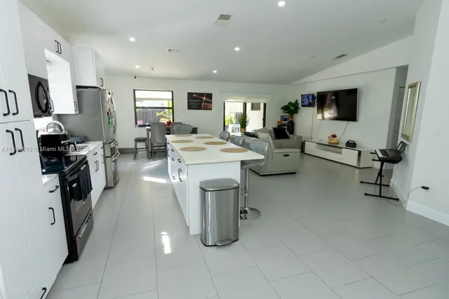 a large room with gym equipment and a flat screen tv