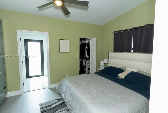 a bedroom with a bed and a walk in closet