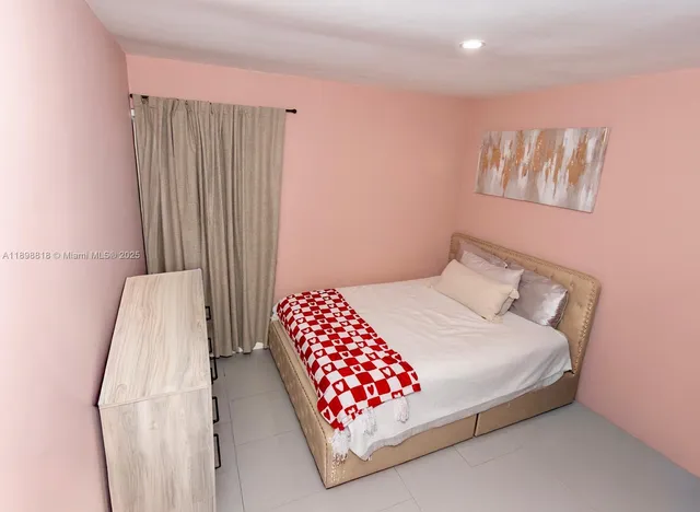a bedroom with a bed and a painting on the wall