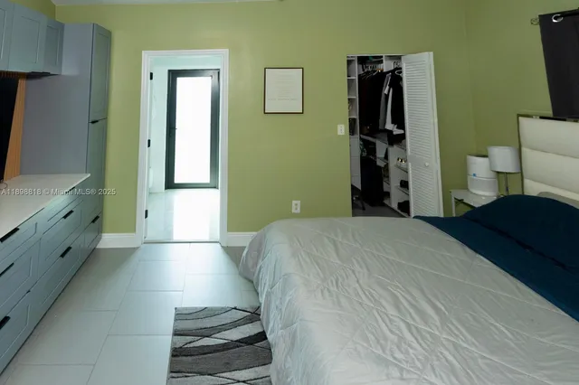 a bedroom with a bed and a view of bathroom