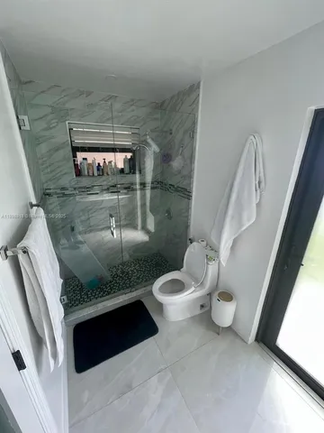 a bathroom with a toilet and a shower